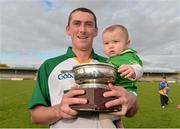 27 October 2012; Ireland's Shane Fennell with his daughter Jennifer, aged 7 months, celebrates with the cup after victory over Scotland. Shinty International, Second Test, Scotland v Ireland, Cusack Park, Ennis, Co. Clare. Picture credit: Diarmuid Greene / SPORTSFILE
