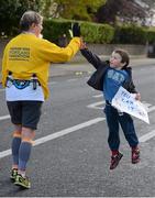 29 October 2012; Five year old Oliver Geoghan, from Clonskeagh, Dublin, offers a 'high five' to Dublin marathon competitor Karen Thomas, from Portland, Oregon, USA, as she makes her way along Clonskeagh Rd during the Dublin Marathon 2012. Picture credit: Ray McManus / SPORTSFILE