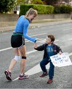 29 October 2012; Five year old Oliver Geoghan, from Clonskeagh, Dublin, offers a 'high five' to a Dublin marathon competitor as she makes her way along Clonskeagh Rd during the Dublin Marathon 2012. Picture credit: Ray McManus / SPORTSFILE