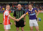 14 October 2012; Bobby Browne, Cuala, left, and Ross O'Carroll, Kilmacud Crokes, shake hands in front of referee Peadar Behan before the Dublin County Senior Hurling Championship Final match between Cuala and Kilmacud Crokes at Parnell Park in Dublin. Photo by Ray McManus/Sportsfile