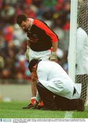 2 February 2003; Umpire Johnny Marlowe, a member of the Kenagh club in Longford, ties the laces of Armagh goalkeeper Paul Hearty during the game. Dublin v Armagh, National Football League Division 1a, Croke Park, Dublin. Football. Picture credit; Ray McManus / SPORTSFILE