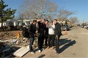 17 November 2012; Bernard Brogan, Paul Flynn, Michael Darragh MacAuley, Dublin, and Colm O'Neill with local home owner John Kelly when members of the 2012 GAA GPA All Stars visited Breezy Point's Irish Community following the devastation caused by Hurricane Sandy. The GPA is assisting in the provision of playing gear and sports equipment for the area's Catholic Youth Organisation's sports programme. Breezy Point, Queens, New York, NY, United States. Picture credit: Ray McManus / SPORTSFILE