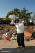 17 November 2012; Local home owner John Kelly, with family connections to Mullingar, Co. Westmeath, holds the Sam Maguire cup when members of the 2012 GAA GPA All Stars visited Breezy Point's Irish Community following the devastation caused by Hurricane Sandy. The GPA is assisting in the provision of playing gear and sports equipment for the area's Catholic Youth Organisation's sports programme. Breezy Point, Queens, New York, NY, United States. Picture credit: Ray McManus / SPORTSFILE