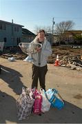 17 November 2012; Local home owner Paddy Cosgrave, from Cappamore, Co. Limerick, holds the Sam Maguire cup when members of the 2012 GAA GPA All Stars visited Breezy Point's Irish Community following the devastation caused by Hurricane Sandy. The GPA is assisting in the provision of playing gear and sports equipment for the area's Catholic Youth Organisation's sports programme. Breezy Point, Queens, New York, NY, United States. Picture credit: Ray McManus / SPORTSFILE