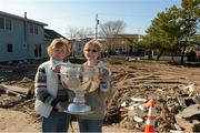 17 November 2012; Local home owners Eileen Flanagan and Josie McNally, from Mount Charles, Co. Donegal, hold the Sam Maguire cup when members of the 2012 GAA GPA All Stars visited Breezy Point's Irish Community following the devastation caused by Hurricane Sandy. The GPA is assisting in the provision of playing gear and sports equipment for the area's Catholic Youth Organisation's sports programme. Breezy Point, Queens, New York, NY, United States. Picture credit: Ray McManus / SPORTSFILE