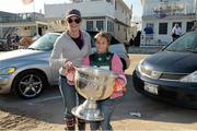 17 November 2012; Ann Marie Campbell and her daughter Julia with the Sam Maguire Cup when  members of the 2012 GAA GPA All Stars visited Breezy Point's Irish Community following the devastation caused by Hurricane Sandy. The GPA is assisting in the provision of playing gear and sports equipment for the area's Catholic Youth Organisation's sports programme. Breezy Point, Queens, New York, NY, United States. Picture credit: Ray McManus / SPORTSFILE