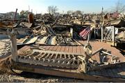 17 November 2012; An American Flag flies amongst the burnt out remains of a home as members of the 2012 GAA GPA All Stars visited Breezy Point's Irish Community following the devastation caused by Hurricane Sandy. The GPA is assisting in the provision of playing gear and sports equipment for the area's Catholic Youth Organisation's sports programme. Breezy Point, Queens, New York, NY, United States. Picture credit: Ray McManus / SPORTSFILE