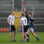18 November 2012; Referee Martin Sludden issues Niall McEvoy, 3, Kilcoo, with a red card in the second half. AIB Ulster GAA Football Senior Championship Semi-Final, St Gall's, Antrim v Kilcoo, Down, Athletic Grounds, Armagh. Picture credit: Oliver McVeigh / SPORTSFILE