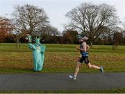 18 November 2012; Eventual winner Wayne Reid, from Athlone, Co. Westmeath, passes  'The Statue of Liberty' Christabel O'Loughlin, from Clonsilla, Dublin, during the New York Dublin Marathon. The marathon was organised as a result of the cancellation of the official New York marathon due to the devastation caused by Hurricane Sandy. Phoenix Park, Dublin. Picture credit: Brian Lawless / SPORTSFILE