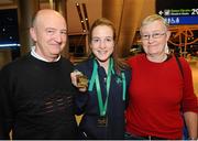 10 December 2012; Team Ireland's Fionnuala Britton who won two gold medals, one in the Senior Women's race and the other as a  member of the overall winning team at the SPAR European Cross Country Championships in Budapest, Hungary, pictured with her parents Helen and Eoin on her return at Dublin Airport. Picture credit: David Maher / SPORTSFILE
