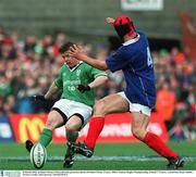 8 March 2003; Ireland's Brian O'Driscoll kicks possession ahead of Fabien Pelous, France. RBS 6 Nations Rugby Championship, Ireland V France, Lansdowne Road, Dublin.  Picture Credit; Matt Browne / SPORTSFILE