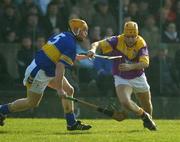 16 March 2003; Michael Jordan, Wexford, in action against Tipperary's Eamonn Corcoran. Allianz National Hurling League, Tipperary v Wexford, McDonagh Park, Nenagh, County Tipperary. Picture credit; Ray McManus / SPORTSFILE *EDI*