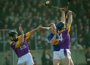 16 March 2003; Ger O'Grady, Tipperary, in action against Wexford defenders Darren Stamp, left, and Colm Kehoe. Allianz National Hurling League, Tipperary v Wexford, McDonagh Park, Nenagh, County Tipperary. Picture credit; Ray McManus / SPORTSFILE *EDI*