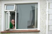 6 January 2013; Shane Heffernan, from Tullamore, Co. Offaly, watches the game from his upstairs window. Bórd na Móna O'Byrne Cup, Group C, Offaly v Laois, O'Connor Park, Tullamore, Co. Offaly. Picture credit: Barry Cregg / SPORTSFILE