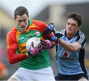 6 January 2013; Brendan Murphy, Carlow, is tackled by Dublin's Eric Lowndes. Bórd na Móna O'Byrne Cup, Group B, Carlow v Dublin, Dr. Cullen Park, Carlow. Picture credit: Ray McManus / SPORTSFILE
