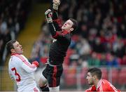 6 January 2013; Tyrone goalkeeper Niall Morgan, alongside team-mate Conor Gormley, punches the ball clear of Lee Kennedy, Derry. Power NI Dr. McKenna Cup, Section C, Round 1, Tyrone v Derry, Healy Park, Omagh, Co. Tyrone. Picture credit: Oliver McVeigh / SPORTSFILE