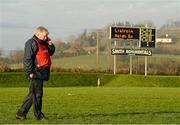 13 January 2013; Leitrim joint manager Barney Breen, on his mobile phone during a radio interview with the final score on the scoreboard at the end of the game. Connacht FBD League Section B, Leitrim v Mayo, Páirc Seán O'Heslin, Ballinamore, Co. Leitrim. Picture credit: David Maher / SPORTSFILE