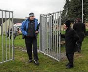 20 January 2013; 'Maor' Tommy Gilmartin attends to the gate as Laois manager, Seamus Plunkett enters the field. Bord na Móna Walsh Cup, First Round, Laois v UCD, Rathdowney-Errill GAA Club, Kelly Daly Park, Rathdowney, Co. Laois. Picture credit: Dáire Brennan / SPORTSFILE
