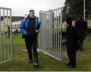 20 January 2013; 'Maor' Tommy Gilmartin attends to the gate as Laois manager Seamus Plunkett enters the field. Bord na Móna Walsh Cup, First Round, Laois v UCD, Rathdowney-Errill GAA Club, Kelly Daly Park, Rathdowney, Co. Laois. Picture credit: Dáire Brennan / SPORTSFILE