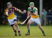 27 January 2013; Del Morkham, Offaly, in action against P. J. Nolan, Wexford. Bórd na Móna Walsh Cup, Second Round, Wexford v Offaly, Wexford v Offaly, Pairc Naomh Brid, Blackwater GAA Club, Co. Wexford. Picture credit: Ray McManus / SPORTSFILE