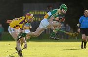 27 January 2013; Del Morkham, Offaly, skips over a tackle from Wexford's Andrew Shore. Bórd na Móna Walsh Cup, Second Round, Wexford v Offaly, Wexford v Offaly, Pairc Naomh Brid, Blackwater GAA Club, Co. Wexford. Picture credit: Ray McManus / SPORTSFILE