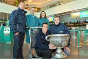 31 January 2013; Aer Lingus flight attendants Grainne Kelly, left, and Orla Kelly with former Galway hurler Ollie Canning, left, Tyrone footballer Brian McGuigan, and Tipperary hurler Lar Corbett, with the Sam Maguire Cup, prior to their departure to Breezy Point in New York today as part of a GPA work party where they will assist with the reconstruction of the local youth sports facilities destroyed during Hurricane Sandy. The party is travelling with the support of Aer Lingus. Dublin Airport, Dublin. Picture credit: Barry Cregg / SPORTSFILE