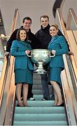 31 January 2013; Aer Lingus flight attendants Orla Kelly, left, and Grainne Kelly hold the Sam Maguire Cup with Tyrone footballer Brian McGuigan, left, and Tipperary hurler Lar Corbett prior to their departure to Breezy Point in New York today as part of a GPA work party where they will assist with the reconstruction of the local youth sports facilities destroyed during Hurricane Sandy. The party is travelling with the support of Aer Lingus. Dublin Airport, Dublin. Picture credit: Barry Cregg / SPORTSFILE