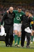 10 February 2013; Jonathan Sexton, Ireland, is led from the pitch by team doctor Dr. Eanna Falvey, left, and team physio James Allen after picking up an injury. RBS Six Nations Rugby Championship, Ireland v England, Aviva Stadium, Lansdowne Road, Dublin. Picture credit: Brendan Moran / SPORTSFILE