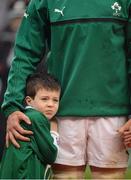 10 February 2013; Ireland mascot John Cotter, age 7, from Clontarf, Dublin, shelters from the rain, cold and pre-match fireworks, next to team captain Jamie Heaslip, before the game. RBS Six Nations Rugby Championship, Ireland v England, Aviva Stadium, Lansdowne Road, Dublin. Picture credit: Brendan Moran / SPORTSFILE