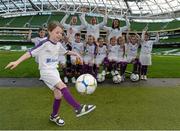 17 February 2013; Zoe Leonard, age 9, from Dublin, shows off her skills for Republic of Ireland internationals Lauren Dwyer, left, Rianna Jarrett, and Megan Campbell, right, along with Aviva Soccer Sister participants, from left, Ria Murray, age 7, from Meath, Chloe Lawless, age 9, from Dublin, Isabelle Carr, age 11, from Meath, Aine Logan, age 10, from Meath, Ellie Burke, age 9, from Meath, Keelin Reddin, age 7, from Meath, Katie Culhane, ae 7, from Dublin, Kacey McGrane, age 9, from Meath, and Amy Hart-Murray, age 9, from Meath in attendance at the launch of the FAI Aviva Soccer Sisters. The highlight of the 2013 programme will be the Aviva Soccer Sisters Easter camps, taking place in over 60 locations around the country and providing over 2,000 girls an opportunity to get involved in football. All of the camps will be overseen by FAI accredited coaches. A full county by county camp breakdown is available on www.fai.ie/soccersisters. Aviva Stadium, Lansdowne Road, Dublin. Picture credit: Brian Lawless / SPORTSFILE