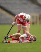 16 February 2013; Eddie McCloskey, Loughgiel Shamrocks, lies injured as Declan Laverty comes to his aid. AIB GAA Hurling All-Ireland Senior Club Championship, Replay, St Thomas v Loughgiel Shamrocks, St. Tiernach's Park, Clones, Co. Monaghan. Picture credit: Oliver McVeigh / SPORTSFILE