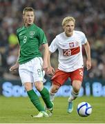 6 February 2013; James McCarthy, Republic of Ireland, in action against Daniel Lukasik, Poland. International Friendly, Republic of Ireland v Poland, Aviva Stadium, Lansdowne Road, Dublin. Picture credit: Brian Lawless / SPORTSFILE
