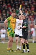 3 March 2013; Referee Joe McQuillan issues a yellow card to Eamonn McGee, Donegal, and Matthew Donnelly, Tyrone. Allianz Football League, Division 1, Tyrone v Donegal, Healy Park, Omagh, Co. Tyrone. Picture credit: Oliver McVeigh / SPORTSFILE