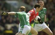 11 May 2003; Maurice McCarthy, Cork, in action against Limerick's Stephen Kelly (12) and Brian Begley. Bank of Ireland Munster Senior Football Championship, Cork v Limerick, Pairc Ui Chaoimh, Cork. Picture credit; Brendan Moran / SPORTSFILE *EDI*