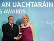 15 March 2013; Mary Gavin is presented with her GAA President's Awards for 2013 award by Uachtarán Chumann Lúthchleas Gael Liam Ó Néill. Originally from Mt. Bellew/Moylough, Co. Galway, Mary Gavin travelled to the Netherlands in 1982 on a short Summer holiday and ended up making a life for herself there for the last 30 years. In that time, she has pioneered new ways in how to promote the GAA brand in new countries and in her club The Hague  and is one of the finest international ambassadors of our game abroad. GAA President's Awards 2013, Croke Park, Dublin. Picture credit: Brian Lawless / SPORTSFILE