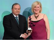 15 March 2013; Mary Gavin is presented with her GAA President's Awards for 2013 award by Uachtarán Chumann Lúthchleas Gael Liam Ó Néill. Originally from Mt. Bellew/Moylough, Co. Galway, Mary Gavin travelled to the Netherlands in 1982 on a short Summer holiday and ended up making a life for herself there for the last 30 years. In that time, she has pioneered new ways in how to promote the GAA brand in new countries and in her club The Hague  and is one of the finest international ambassadors of our game abroad. GAA President's Awards 2013, Croke Park, Dublin. Picture credit: Brian Lawless / SPORTSFILE