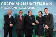 15 March 2013; Marie Uí Sé, wife of the late Páidí Ó Sé, of Ceann Trá, Co Chiarraí, and her nephew Fergal Ó Sé, right, are presented with their GAA President's Award for 2013 by Uachtarán Chumann Lúthchleas Gael Liam Ó Néill in the company of Neil Hosty, AIB, left, and Pól Ó Gallchóir, Ceannaái TG4. The Ó Sé Family of Ceann Trá, Co Chiarraí, have made an incalculable contribution to Gaelic football and by extension the GAA over a prolonged period that stretches across two generations and five decades. The late Páidí Ó Sé is considered to be one of the greatest footballers of all time, winning eight All-Ireland medals, numerous All-Stars and almost every honour the game has to offer. His nephews Fergal, Darragh, Tomás and Marc have represented between them both An Ghaeltacht and Kerry with distinction claiming county, provincial and national honours with the latter two still members of the Kerry senior football team. Páidí’s son Pádraig Óg is a current member of the Kerry U21 panel managed by Darragh. GAA President's Awards 2013, Croke Park, Dublin. Picture credit: Brian Lawless / SPORTSFILE