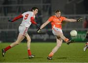 16 March 2013; Kieran Toner, Armagh, kicks a late point despite the tackle of Brian Donnelly, Louth. Allianz Football League, Division 2, Armagh v Louth, Athletic Grounds, Armagh. Picture credit: Oliver McVeigh / SPORTSFILE
