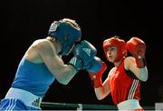 22 March 2013; Yulia Tsiplakova, Ukraine, left, exchanges punches with Katie Taylor, Ireland. Katie Taylor Fight Night, Bord Gais Energy Theatre, Grand Canal Square, Docklands, Dublin. Picture credit: Matt Browne / SPORTSFILE