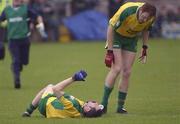 1 June 2003; Donegal's John Haran stands over teammate Brendan Devenney, Devenney was later substituted due to injury. Bank of Ireland Ulster Senior Football Championship, Fermanagh v Donegal, Brewster Park, Enniskillen, Co. Fermanagh. Picture credit; Damien Eagers / SPORTSFILE *EDI*