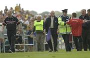 7 June 2003; A Cork football fan is restrained from getting to Cork manager Larry Tompkins during the game against Roscommon. Bank of Ireland Senior Football Championship qualifier, Roscommon v Cork, Dr Hyde Park, Roscommon. Picture credit; Matt Browne / SPORTSFILE *EDI*
