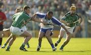 7 June 2003; Peter Queally, Waterford, in action against Limerick players Brian Begley, 11, and Niall Moran. Guinness Munster Senior Hurling  Championship Semi-final replay, Limerick v Waterford, Semple Stadium, Thurles, Co Tipperary. Picture credit; Ray McManus / SPORTSFILE  *EDI*