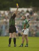 1 June 2003; Clement Smith, Limerick, is shown the yellow card by referee Pat Aherne. Guinness Munster Senior Hurling Championship, Limerick v Waterford, Semple Stadium, Thurles, Co. Tipperary. Picture credit; Brendan Moran / SPORTSFILE *EDI*