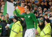 26 March 2013; Glenn Whelan, Republic of Ireland, throws his jersey to a supporter after the match. 2014 FIFA World Cup Qualifier, Group C, Republic of Ireland v Austria, Aviva Stadium, Lansdowne Road, Dublin. Picture credit: Brian Lawless / SPORTSFILE