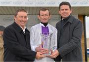 7 April 2013; Jockey Kevin Manning is presented with the trophy by European Tour players Peter Lawrie, right, and Damien McGrane after winning the Irish Open Alleged Stakes on Parish Hall. Curragh Racecourse, The Curragh, Co. Kildare. Picture credit: Matt Browne / SPORTSFILE