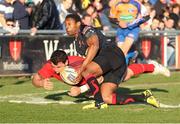 19 April 2013; Paddy Butler, Munster, goes over to score his side's first try despite the tackle of Tonderai Chavhanga, Dragons. Celtic League 2012/13, Round 21, Dragons v Munster, Rodney Parade, Wales. Picture credit: Steve Pope / SPORTSFILE