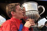 23 April 2013; Jockey Barry Geraghty kisses the trophy after winning the Boylesports.com Champion Steeplechase on Sprinter Sacre. Punchestown Racecourse, Punchestown, Co. Kildare. Picture credit: Barry Cregg / SPORTSFILE