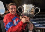 23 April 2013; Jockey Barry Geraghty, with his daughter Siofra, lifts the trophy after winning the Boylesports.com Champion Steeplechase on Sprinter Sacre. Punchestown Racecourse, Punchestown, Co. Kildare. Picture credit: Barry Cregg / SPORTSFILE