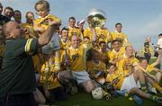 14 June 2003; 18 Month old Nuala McNally, from Belfast, is lifted up as the Antrim team celebrate with the cup after the Guinness Ulster Senior Hurling Championship Final between Antrim and Derry at Casement Park in Belfast. Photo by Damien Eagers/Sportsfile