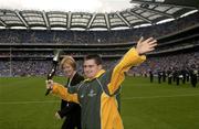 15 June 2003; Special Olympics Athlete Mattew O'Neill, from Portmarnock, Dublin, with Mary Davis, CEO, 2003 Special Olympics World Games, carries a Torch which was presented to the GAA in recognition of the GAA's support of the Games ahead of the Bank of Ireland Leinster Senior Football Championship Semi-Final match between Dublin and Laois at Croke Park in Dublin. Photo by Ray McManus/Sportsfile
